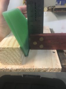 Using square to get fin at 90 degrees to wood.