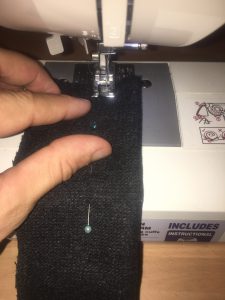 Sewing the sleeve with my sewing machine, using the pins as a guide and removing them as I approach them.